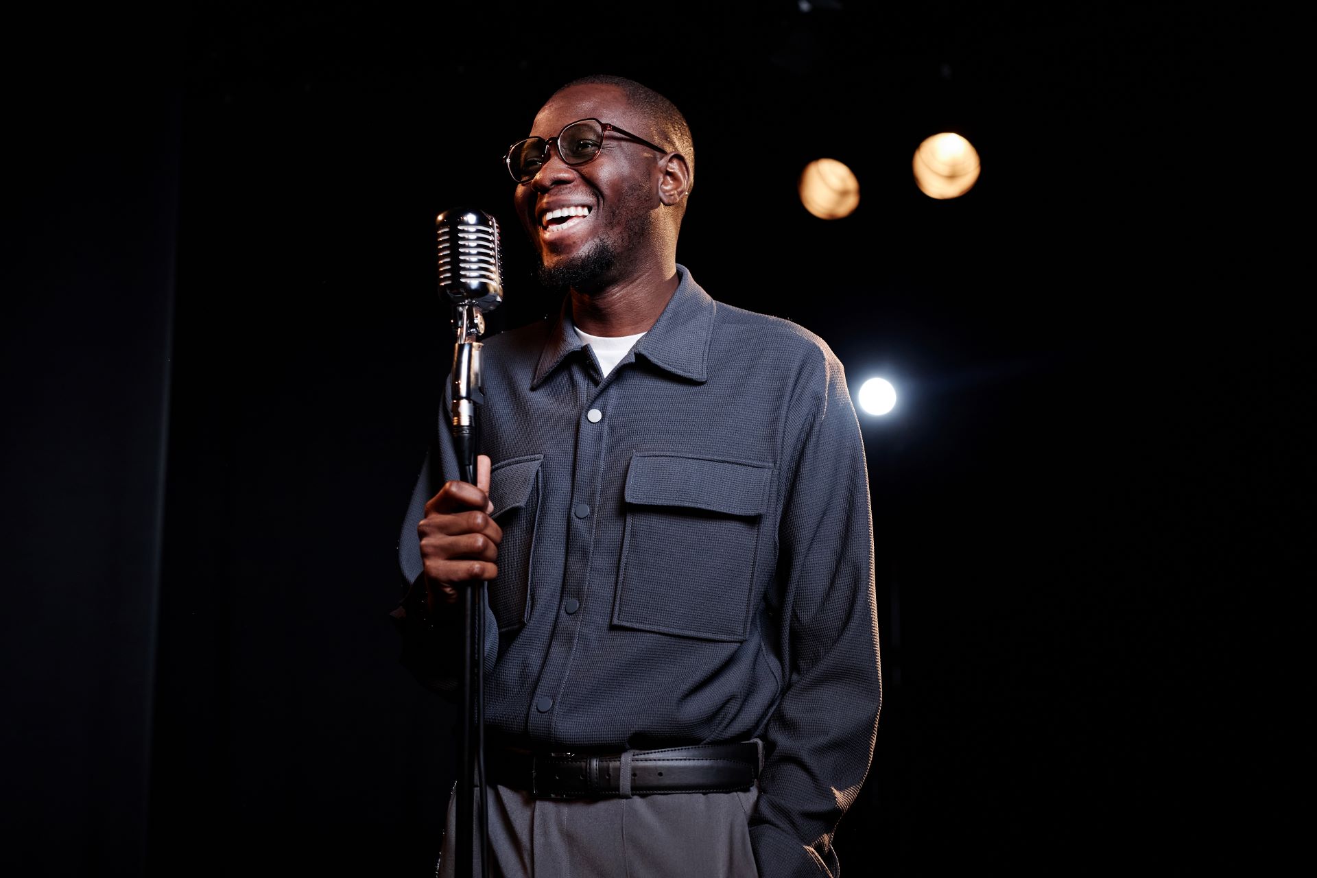 smiling-black-man-performing-in-comedy-show-2025-03-09-08-06-41-utc
